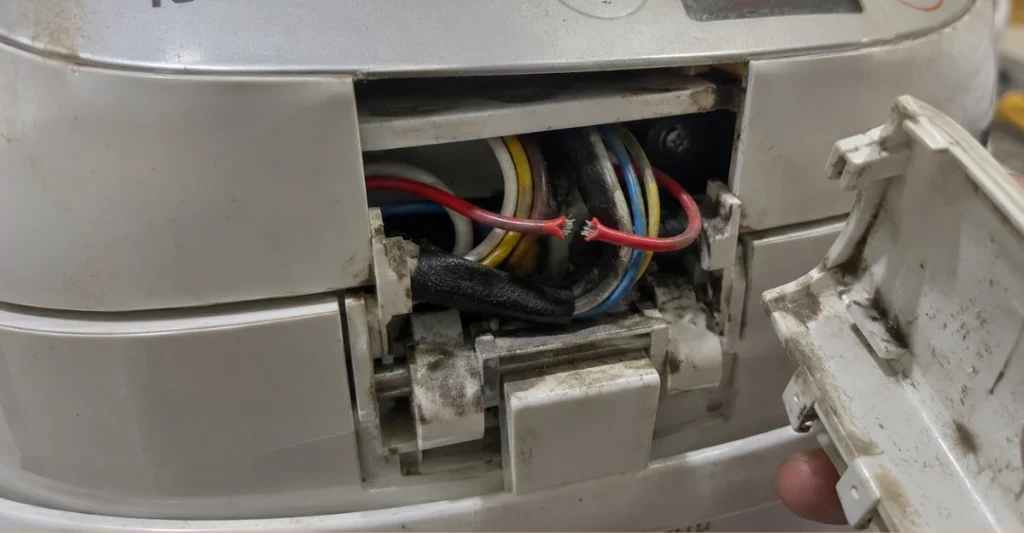 Tháo ốp bản lề phía sau và kiểm tra dây tín hiệu bị đứt trên nồi cơm Toshiba